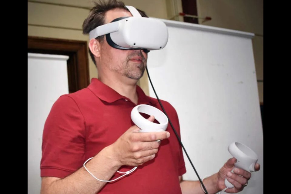 Peter Kuling, University of Guelph professor using the virtual reality headset to enter the virtual world of Hamlet