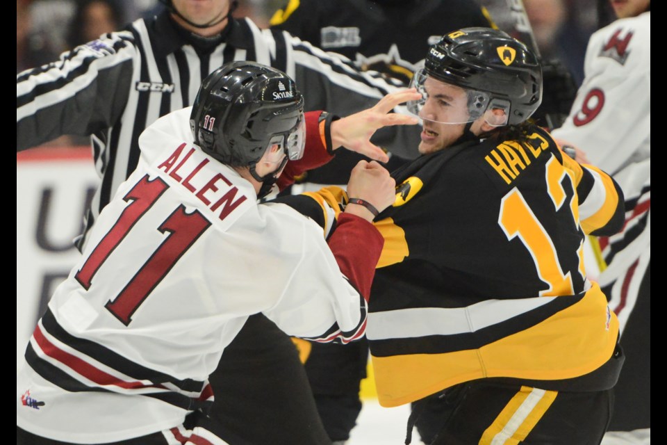 Guelph's Cam Allen fights Hamilton's Avery Hayes Friday night at the Sleeman Centre.