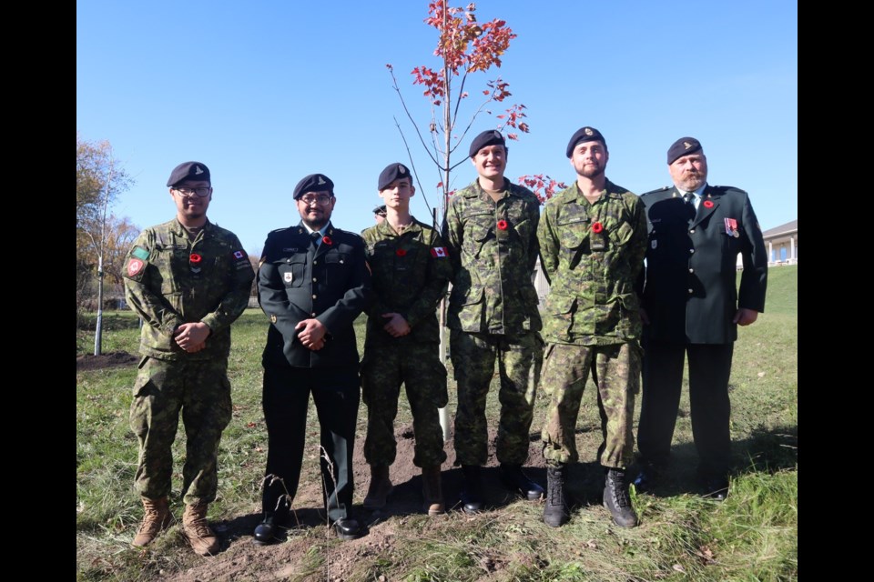 Brandon Nguyen, Thomas Ojapalo,  Zane Ward,  Alistar McClellan, Graeme Wilson and Rick Ivany standing in front of tone of the maple trees they planted.