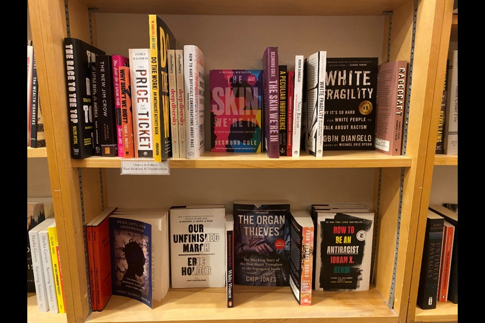 Rows of anti-racist books at The Bookshelf. Twenty of the books were recovered after a man tried to steal them.