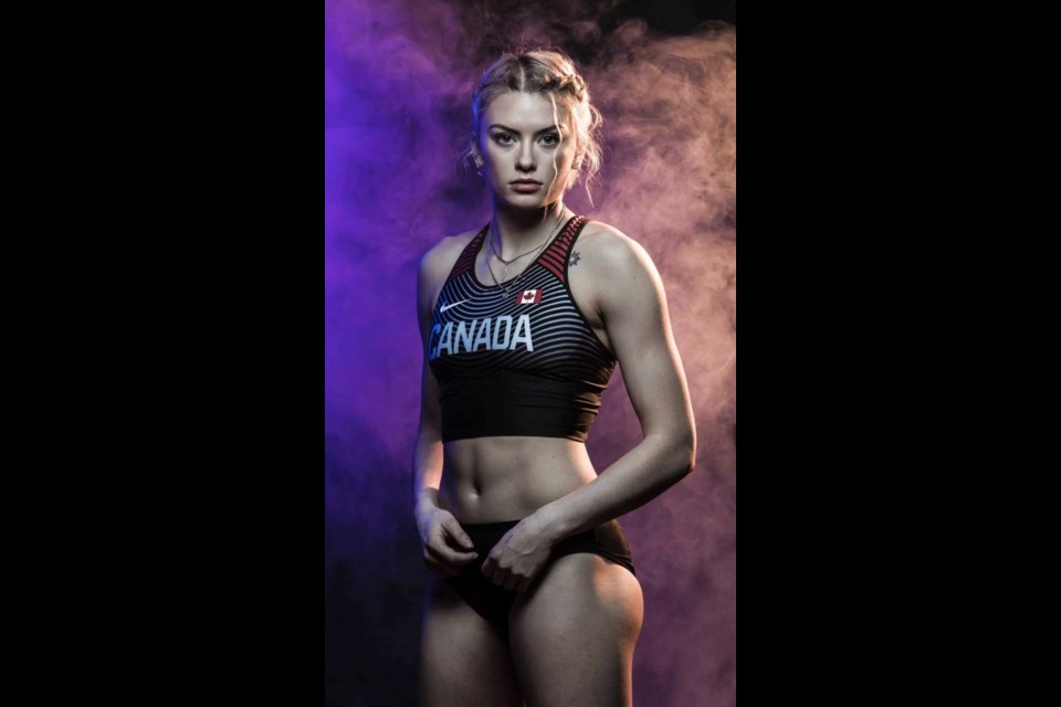Kendra Leger posing for a photo for World U20 Championships representing Canada with the Athletics Canada team in 2018.