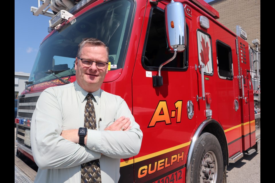 New Guelph Fire Department chief Brian Arnold standing in front of a firetruck at the department headquarters. 