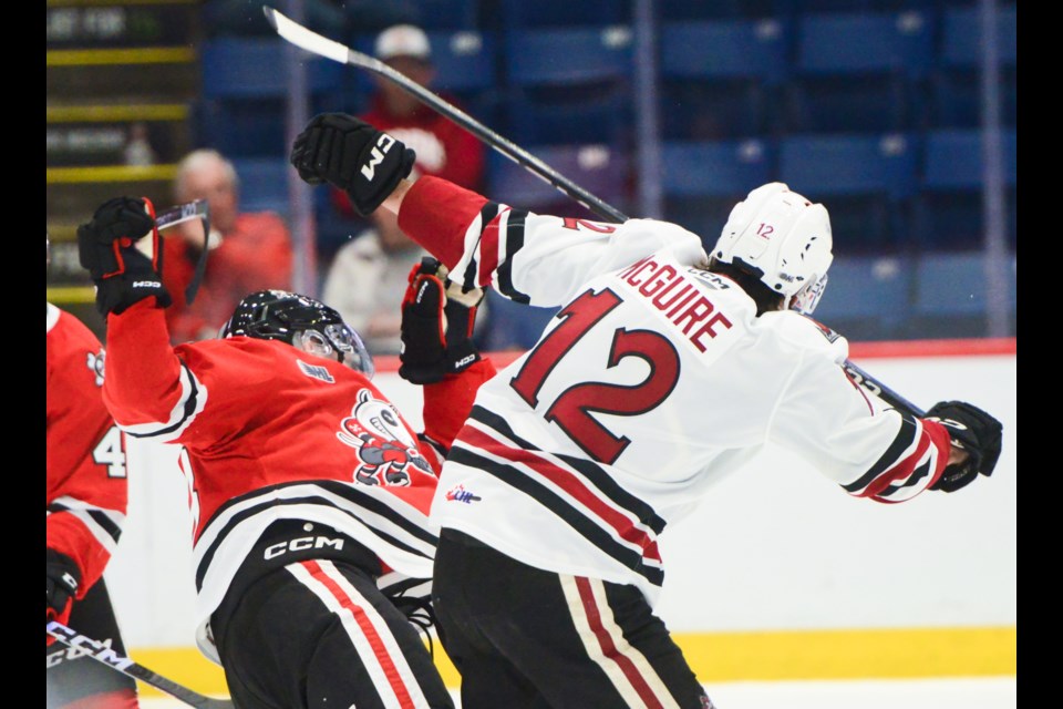 The Guelph Storm's Ryan McGuire checks a Niagara IceDog during pre-season action Friday at the Sleeman Centre.