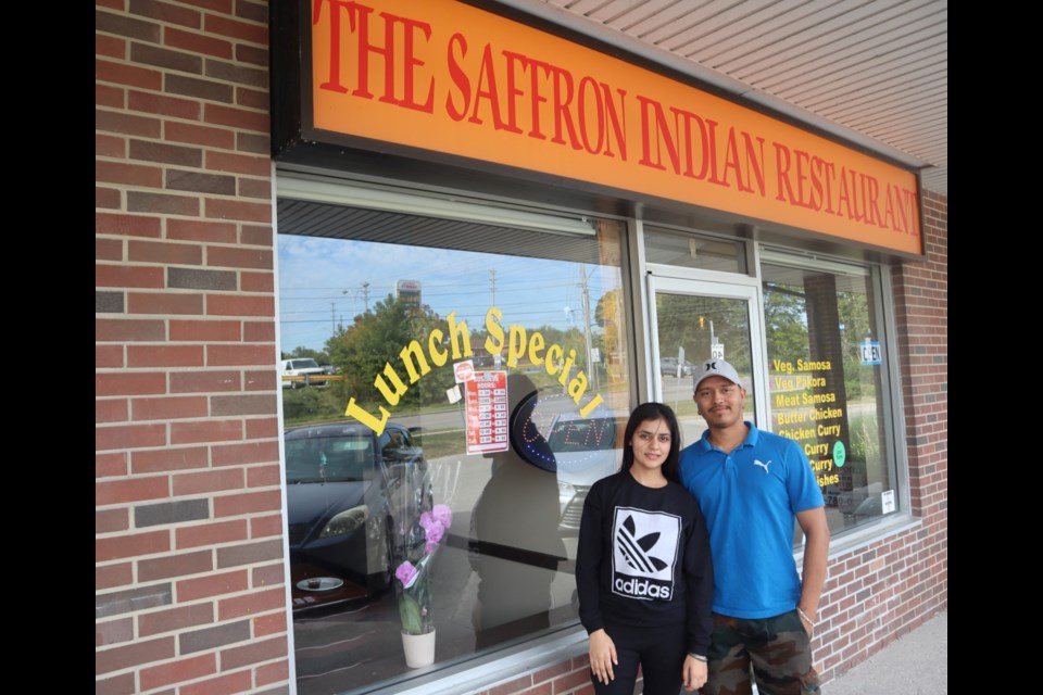 Sharandeep Kaur and Inderpreet Singh outside their newly opened restaurant on Municipal Street.