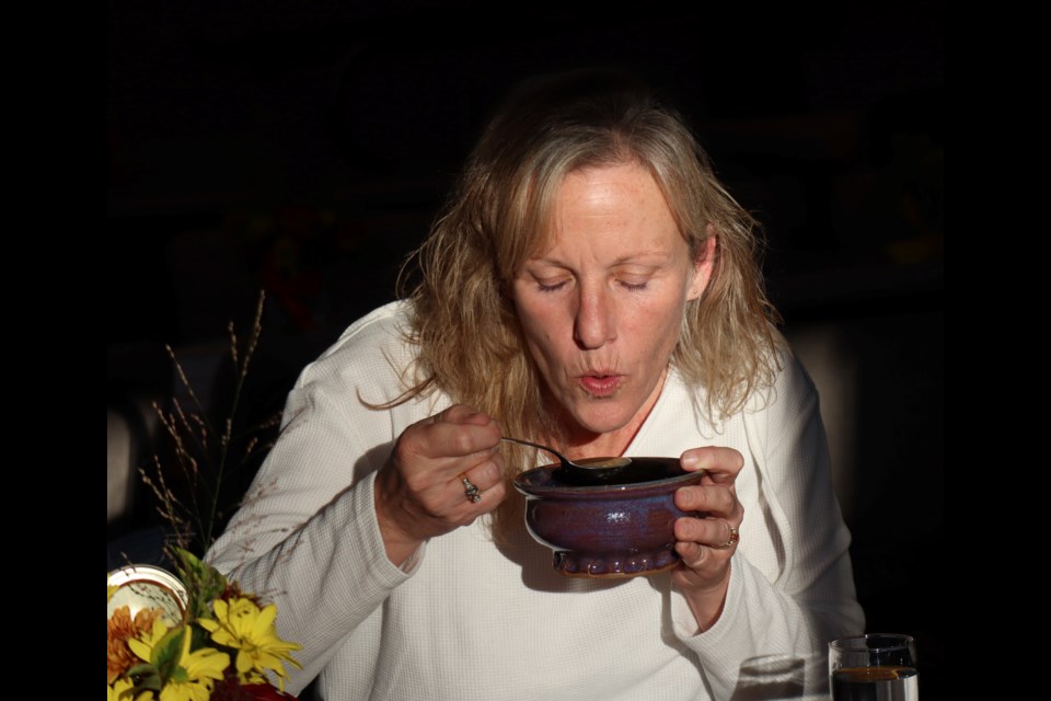 A woman eating a bowl of soup at Harvest Bowls an event put on by Chalmers Community Services Centre.