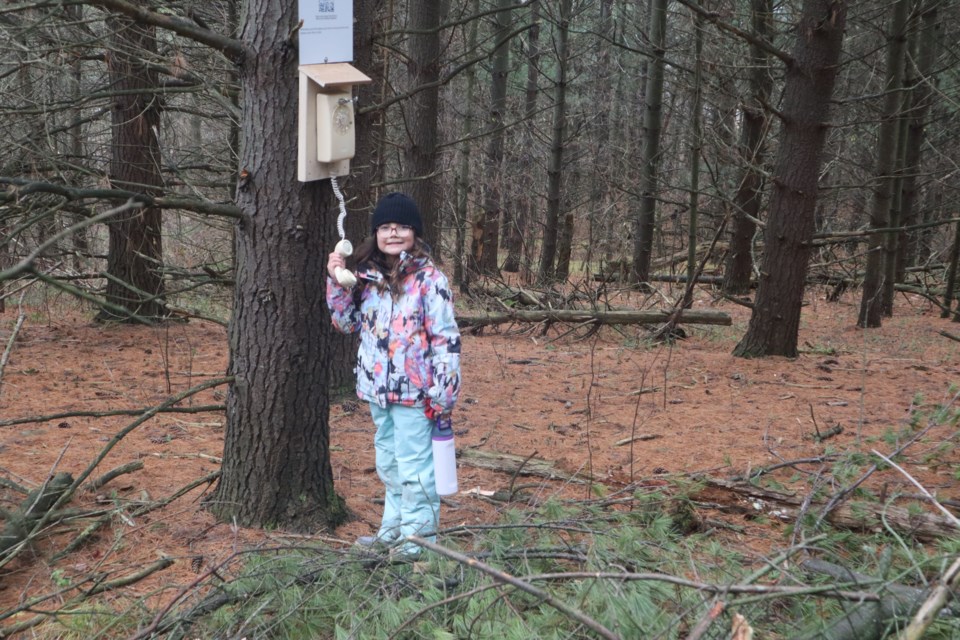 Monica holding the phone upside down at Starkey Hill Conservation Area.