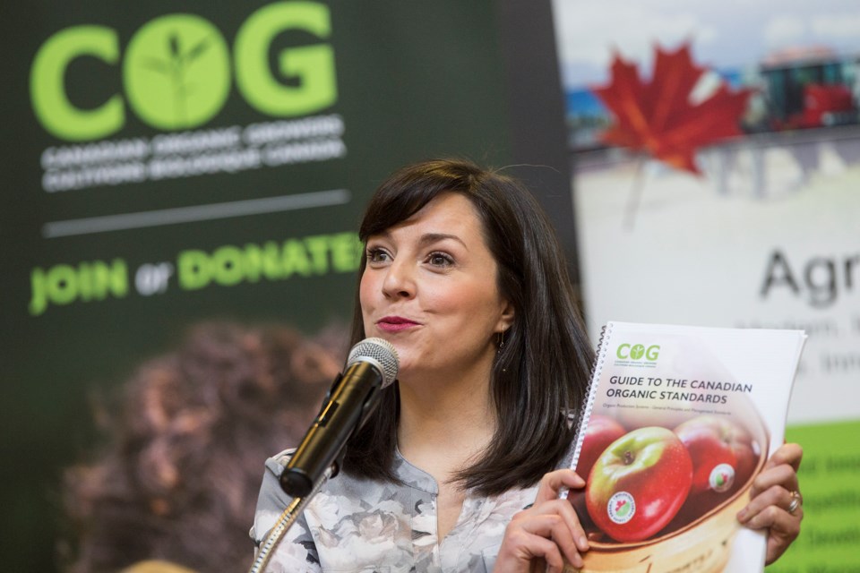 Ashley St. Hilaire, director of programs and government relations with Canadian Organic Growers, holds up a draft copy of a guide to the Canadian Organic Standards during an announcement Jan. 26, 2018 at University Centre. Kenneth Armstrong/GuelphToday