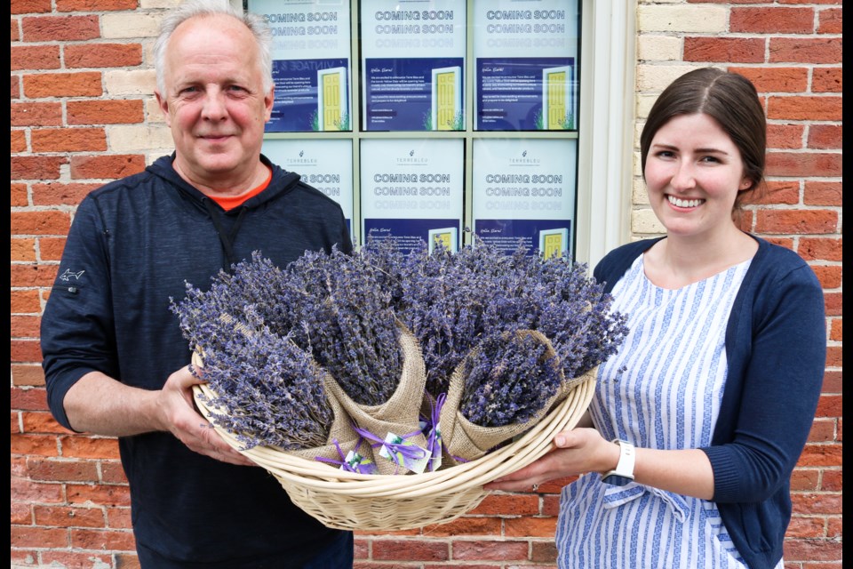 Jim Muzyka and Jasmine Martyniuk hold up a basket of lavender bushels outside the future storefront for Terre Bleu.