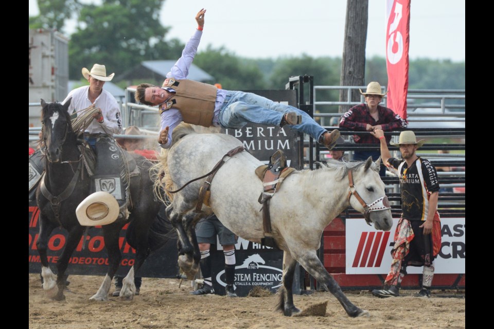 A rider gets thrown during the bronco riding event at the Ultimate Rodeo Tour stop on Durant Road, just outside Guelph, on Friday night. Tony Saxon/GuelphToday