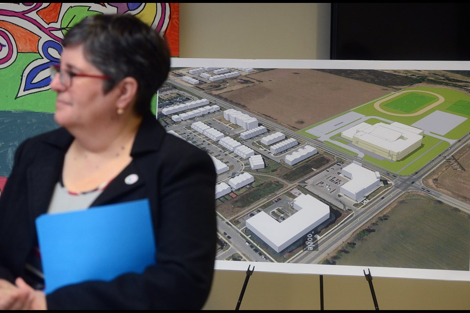 Linda Busuttil, Chairperson of the Upper Grand DIstrict School Board, stands beside a conceptual drawing for a new south end high school that was announced Friday, Jan. 19, 2018, at the board office. Tony Saxon/GuelphToday
