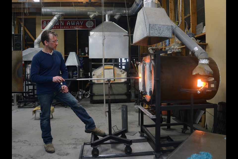 Tim McManus heats up some glass. Tony Saxon/GuelphToday