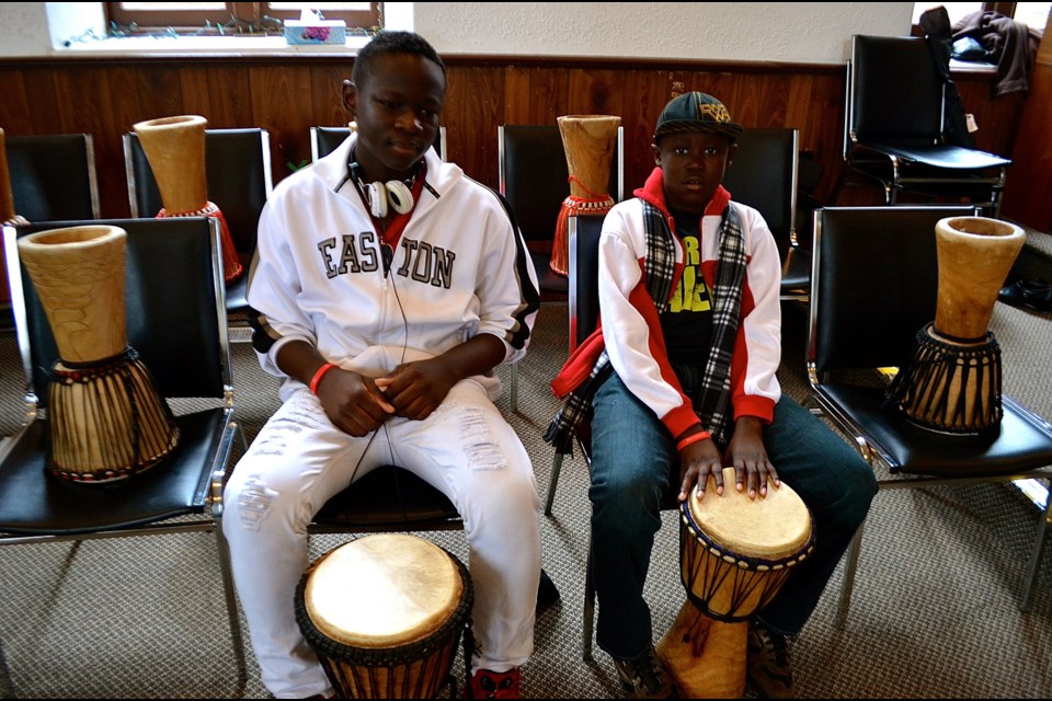 Young drummers Remson Ngandu and Ben Muginga wait for the workshop to begin Saturday, Feb. 25, at Heritage Hall on Essex Street. Troy Bridgeman for GuelphToday.com