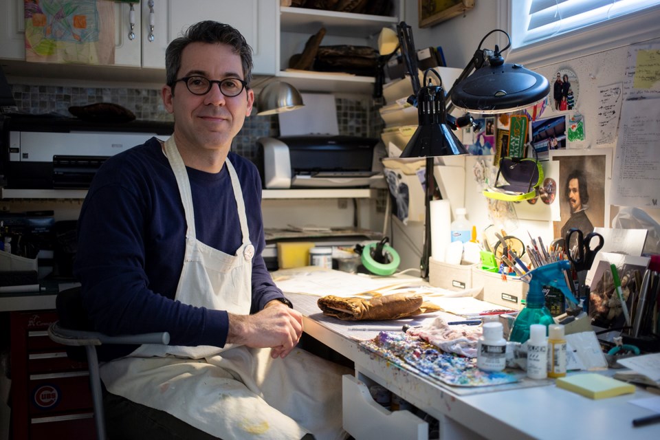 Sean Kane seen in his home studio in Guelph. Kane has found an interesting niche market by creating commemorative painted baseball gloves. Kenneth Armstrong/GuelphToday