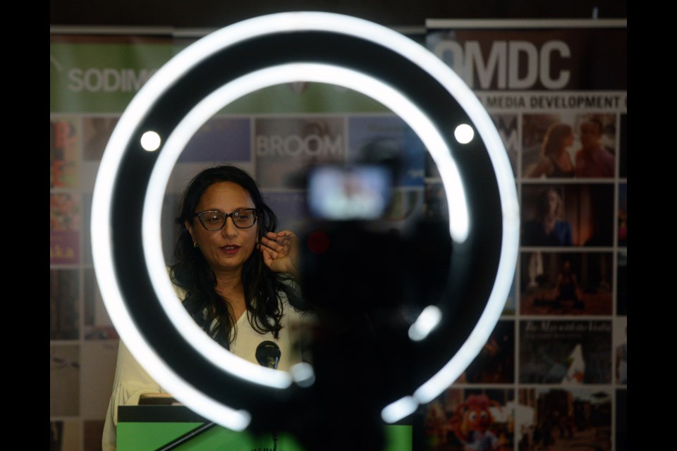 Author and University of Guelph professor Madhur Anand is seen through camea lighting as she reads from her book at a Trillium book prize author reading Thursday, March 16, at the Arboretum. Tony Saxon/GuelphToday
