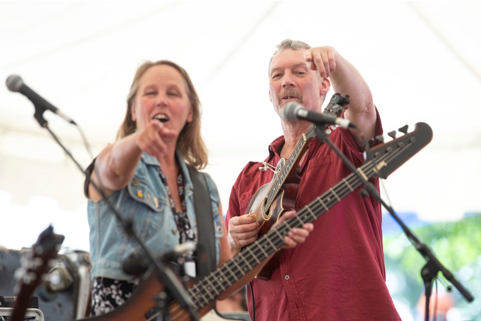 Molly Kurvink and Jeff Bird of Tamarack point to a member of the audience during a set with the band at Hillside Festival on July 7, 2018. Kenneth Armstrong/GuelphToday