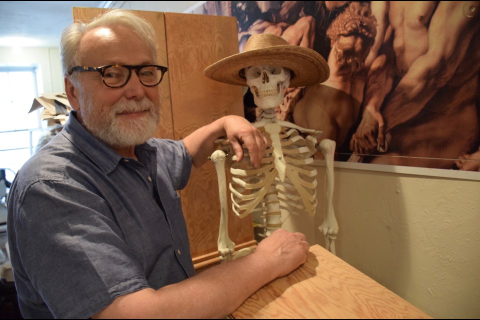 Guelph artist and life drawing instructor Werner Zimmermann with his skeleton friend. 