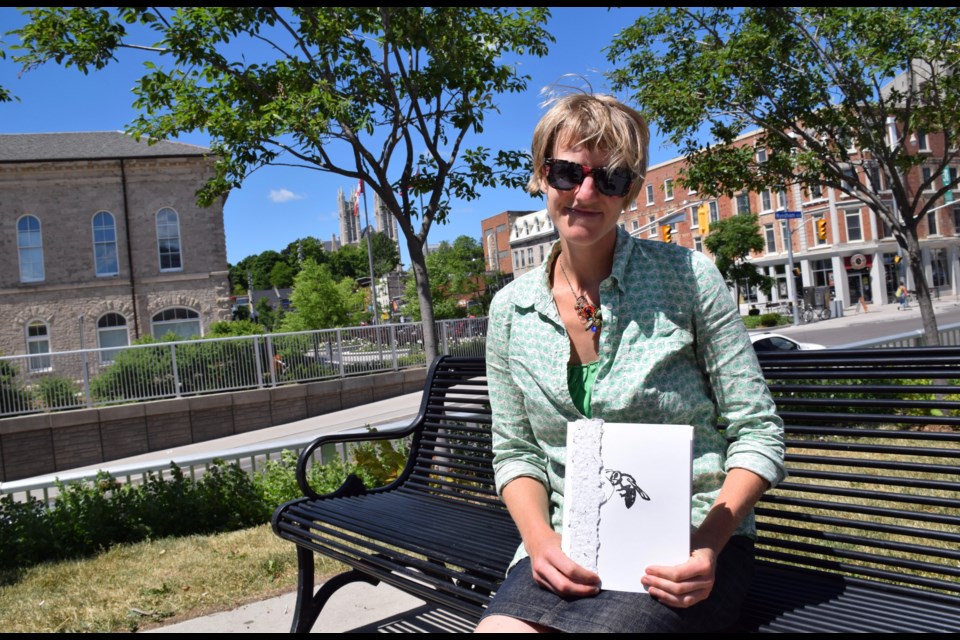Artist Christina Kingsbury with a copy of the book ReMediate, part of an ongoing environmental art project that began at a former landfill site. 