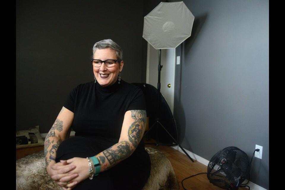 Guelph photographer Julia Busato sits in the basement studio of her home on the city's west side. Tony Saxon/GuelphToday