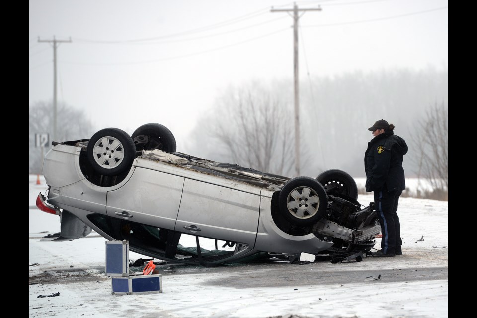 An OPP officer surveys the scene of a serious accident that happened Monday, Dec. 18, 2017, on Highway 6 just north of Guelph. Tony Saxon/GuelphToday