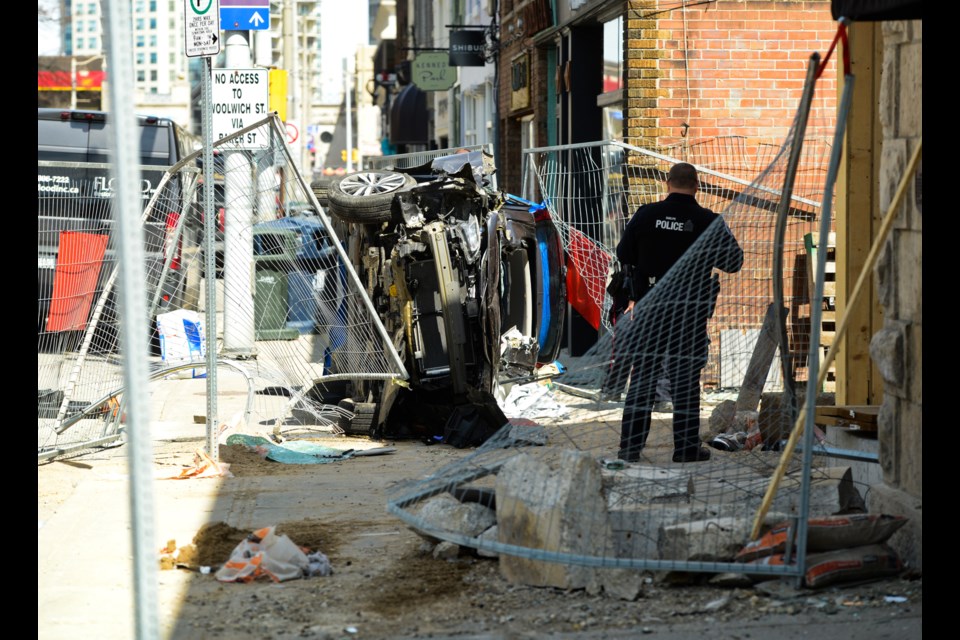 Police monitor the scene of a bad car crash in Downtown Guelph on Quebec Street Wednesday afternoon. Tony Saxon/GuelphToday