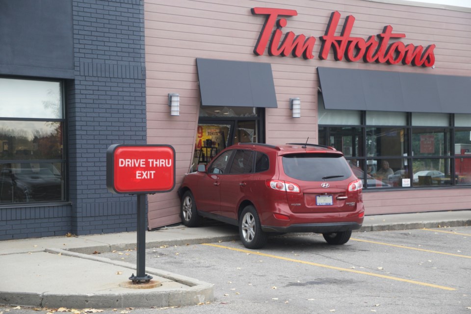 An SUV is lodged in a doorway at the Tim Hortons location at the corner of Imperial Road and Wellington Street Thursday afternoon. Kenneth Armstrong/GuelphToday