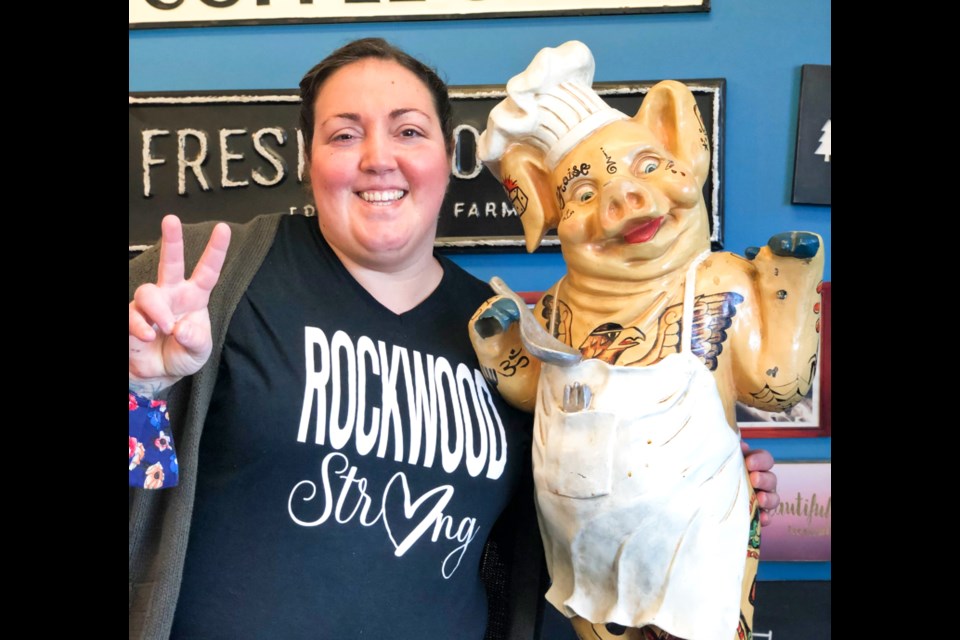 Claudia Goodfellow, owner of Goodfellows Field to Fork, posing with the store's tattoo pig mascot. Supplied photo.