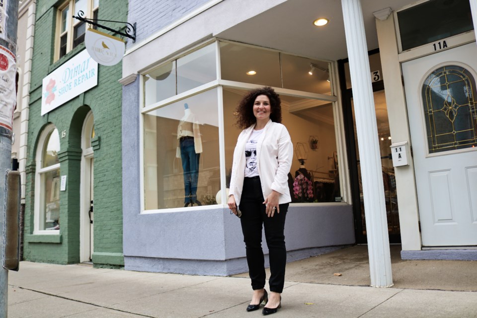 Steph Leombruni, owner of Feather & Foe, stands outside her storefront along Quebec Street.