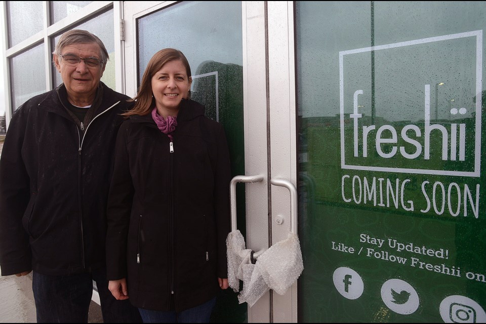 Karen Rogers and her father Wolfgang Stichnothe stand outside the new Freshii restaurant location they are openingsoon in the city's south end. Tony Saxon/GuelphToday