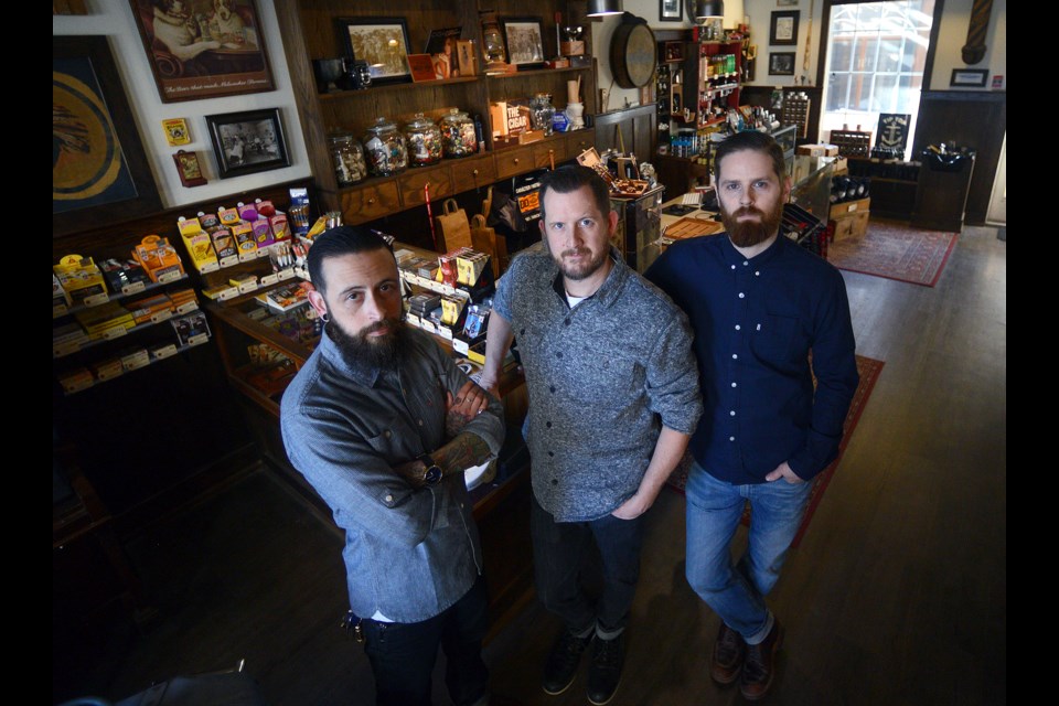 Village Cigar Company & Barbershop co-owners Jerry Filice, left, and Ryan Baker, right, pose in their Burlington location with Sean Edwards, who will be managing the Guelph location. Tony Saxon/GuelphToday