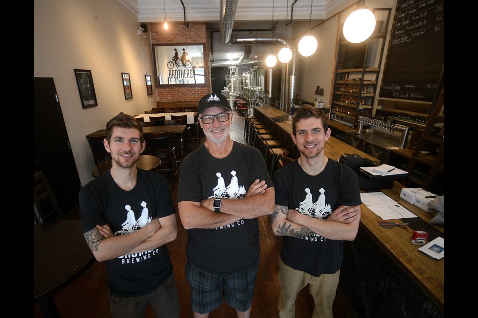 Brothers Colton, left, and Asa Proteau flank business partner Michael Bevan at Brothers Ale House, which is finally set to open after many construction-related delays in Downtown Guelph's historic Petrie Building. Tony Saxon/GuelphToday