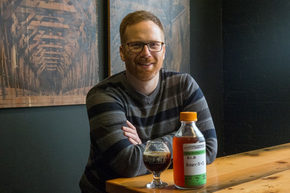 Angus Ross poses at Royal City Brewing with a bottle of yeast from his company, Escarpment Laboratories. Kenneth Armstrong/GuelphToday
