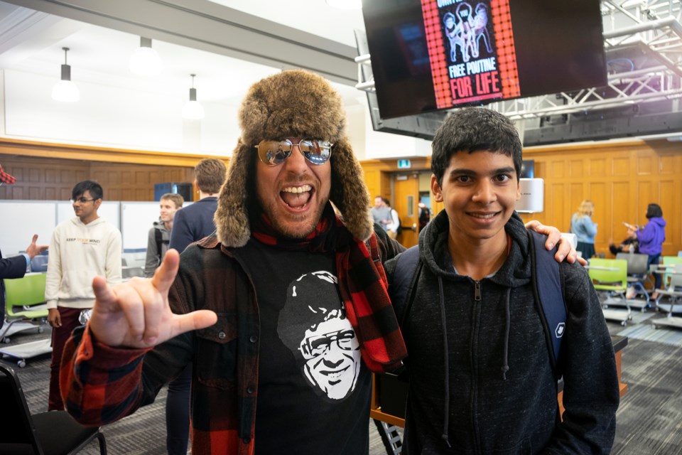 Smoke's Poutinerie CEO Ryan Smolkin poses with first-year U of G student Liam Semelhago during an event on Wednesday. Semelhago did a project on Smolkin's company when he was in high school. Kenneth Armstrong/GuelphToday