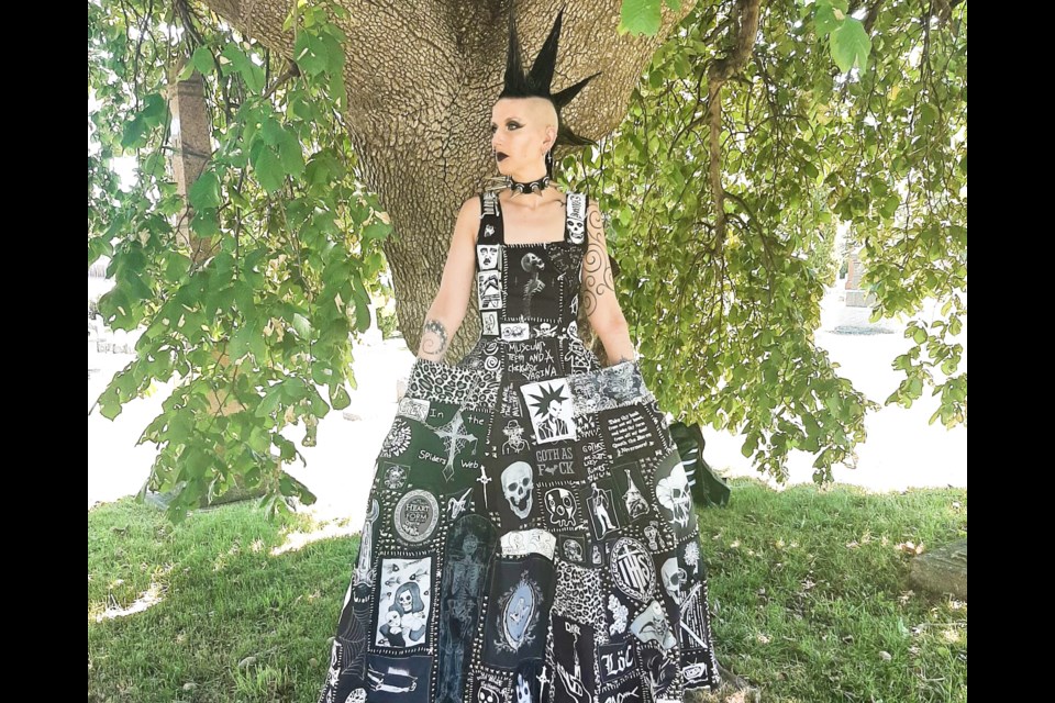 Missy Morrow in a vogue 1956 dress she designed for herself with patches from all over the world.