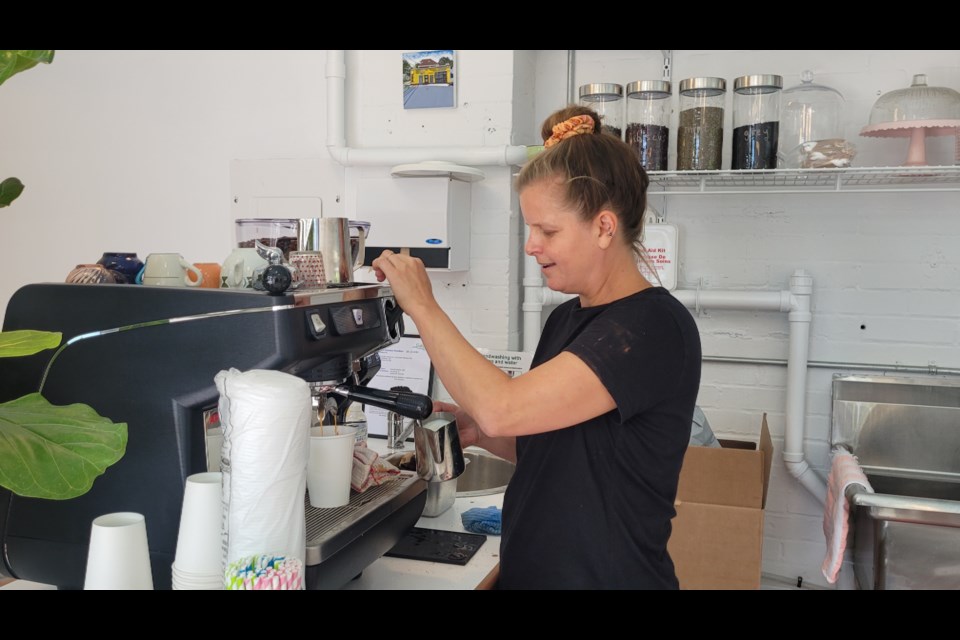 Kim England, owner of the Double Rainbow Café, tests out her coffee making machine ahead of Thursday's soft launch.