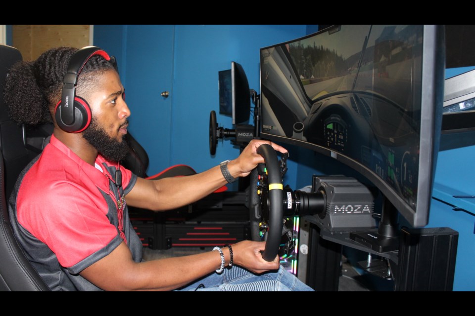 Turn1 Sim Racing senior employee Kyle Benjamin gives one of the rigs a test drive.