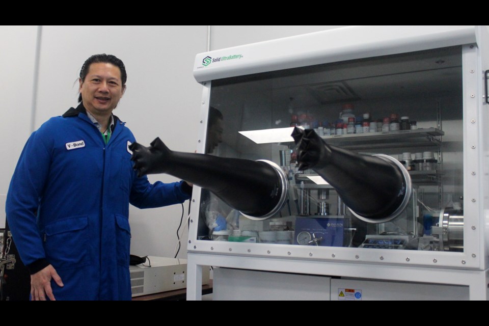 V-Bond Lee, the CEO of Volt Carbon Technologies, stands next to a confinement chamber used to develop batteries. These chambers have very little oxygen and moisture levels.