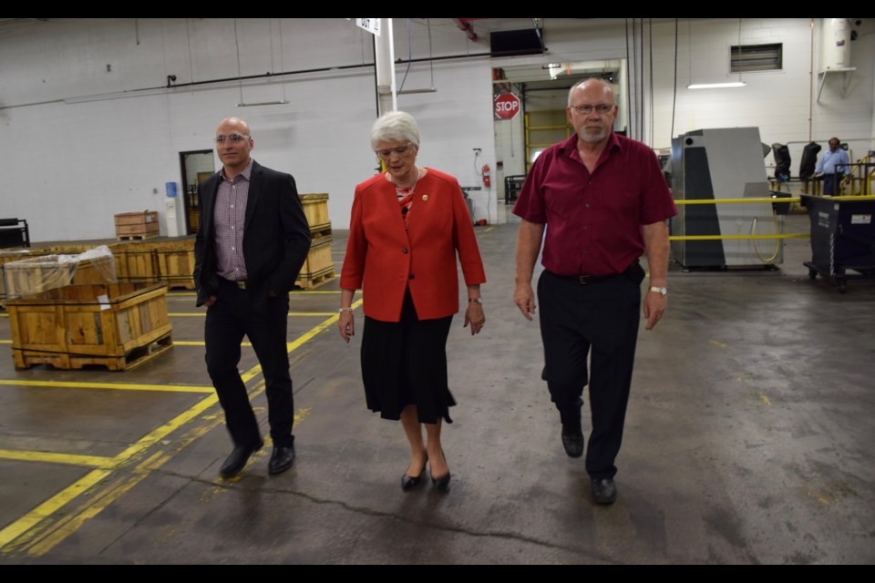 Liz Sandals tours Teutech's Speedvale facility with company CEO Tony Steer, to her right, and Steve Smith, a Government of Ontario senior business advisor. 