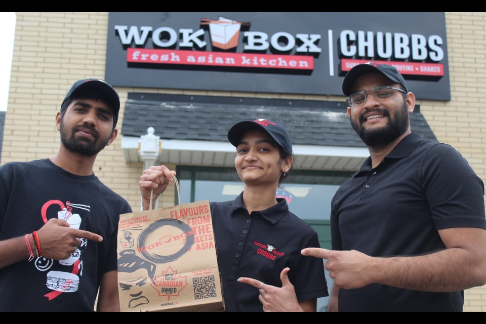 The crew at Wok Box & Chubbs are ready to take your order in its new location at Edinburgh Market Place.
