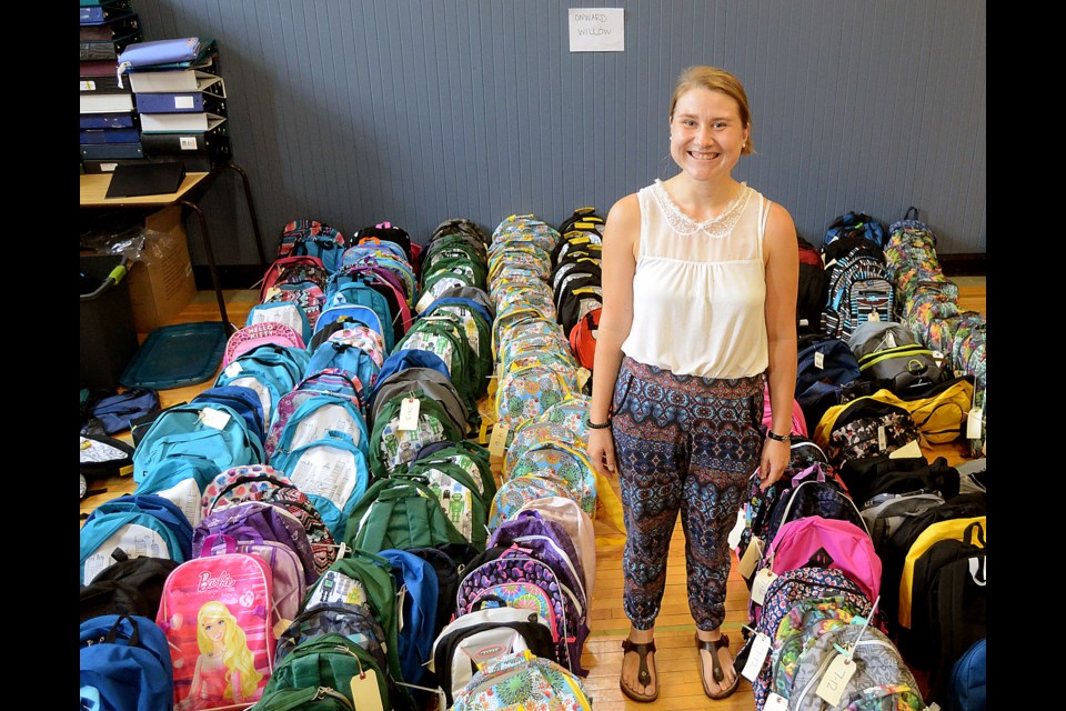 Ursula Rinne, backpack project coordinator at HOPE House, stands in the middle of the 850 back packs collected in 2016. GuelphToday file photo