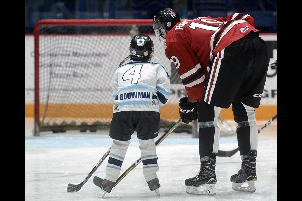 Nickolas Bouwman of the Guelph Giants gets some pointers from the Guelph Storm's Isaac Ratcliffe Saturday, Dec. 9, 2017, at the Sleeman Centre. Tony Saxon/GuelphToday