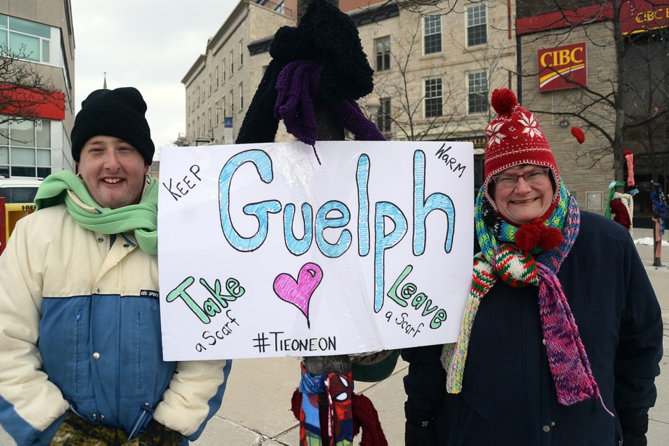 Justin Staines and Melissa Otter were helping keep people warm through the Tie One On free hats, gloves and scarves campaign on Saturday, Feb. 4, 2017, in Downtown Guelph. Tony Saxon/GuephToday