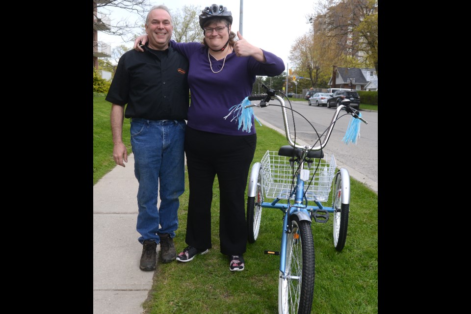 Gino Vettor and Melissa Otter stand beside her new tricycle Wednesday, May 10, 2017. Tony Saxon/GuelphToday