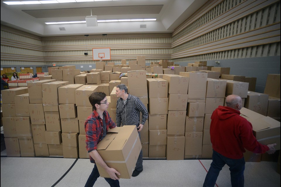 Volunteers stack some of the 1,100 Christmas hampers that will be distributed by the Salvation Army in Guelph on Thursday. Wednesday was packing day. Tony Saxon/GuelphToday