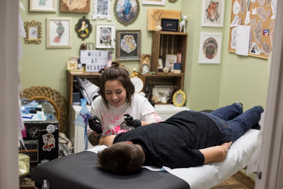 Tattoo artist Allie Charbonneau seen inking Wilma Zondag at Modern Addiction Tattoos. Kenneth Armstrong/GuelphToday
