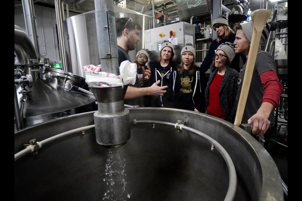 Members of the Queen of Craft get to mix up the beer they came up with at Wellington Brewery. Tony Saxon/GuelphToday