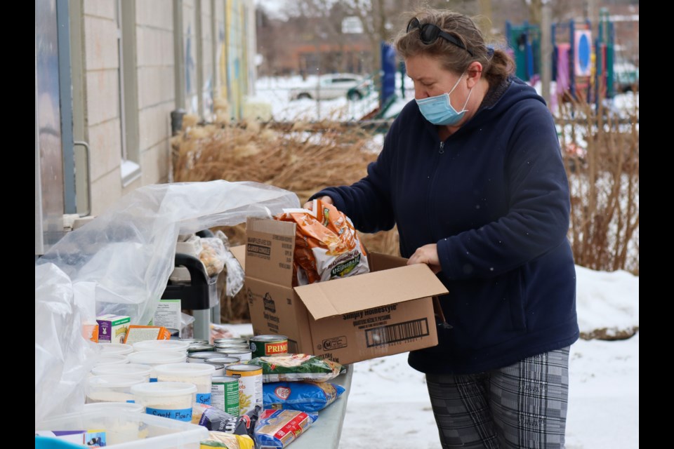 Shaver puts some more food items out on the table. Ariel Deutschmann/GuephToday