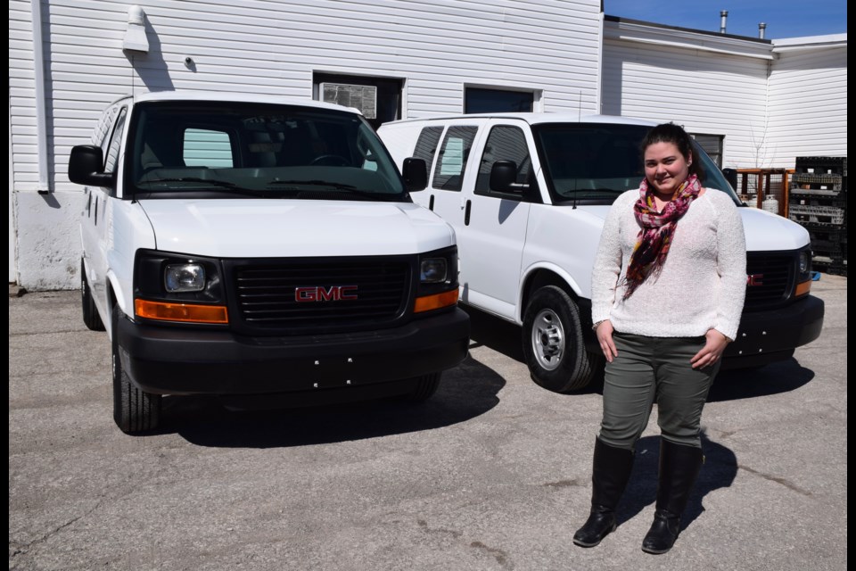 The Guelph Food Bank's Pauline Cripps stands with a pair of nearly new vans the agency was able to purchase thanks for funds from the Walmart Foundation. Rob O'Flanagan/GuelphToday