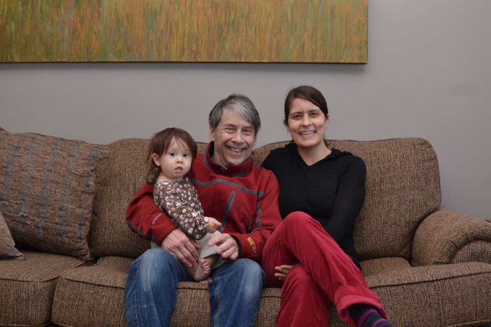 Dr. Liz Sinclair Kruth and Dr. Stephen Sinclair Kruth with their daughter Millie in their home