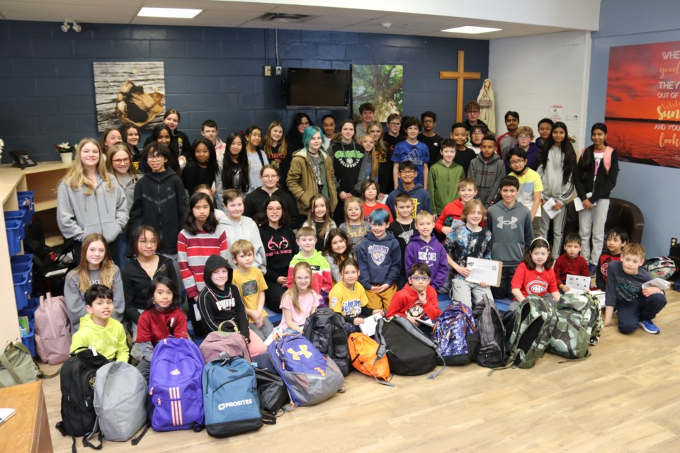 Grade 2 and Grade 6 students from St John Catholic School and Grade 8 students from Holy Trinity Catholic School joined forces in a project to donate items to The Bench, and bake pizza, cupcakes and cookies for Royal City Mission.