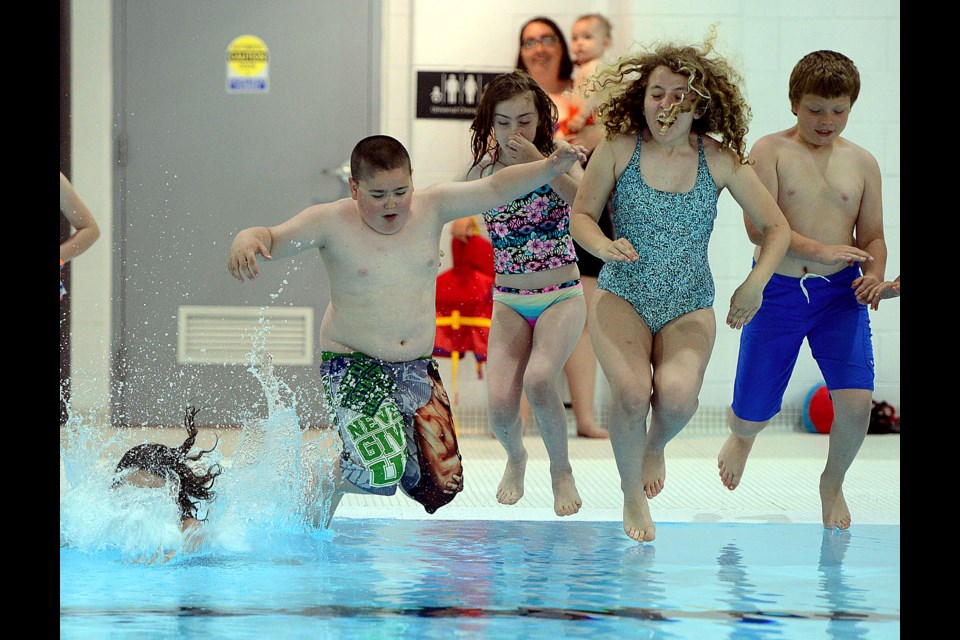 Children leap into the Victor Davis Pool at the Victoria Road Recreation Centre Saturday, June 24, 2017, after it was officially reopened after a $15 million renovation. Tony Saxon/GuelphToday